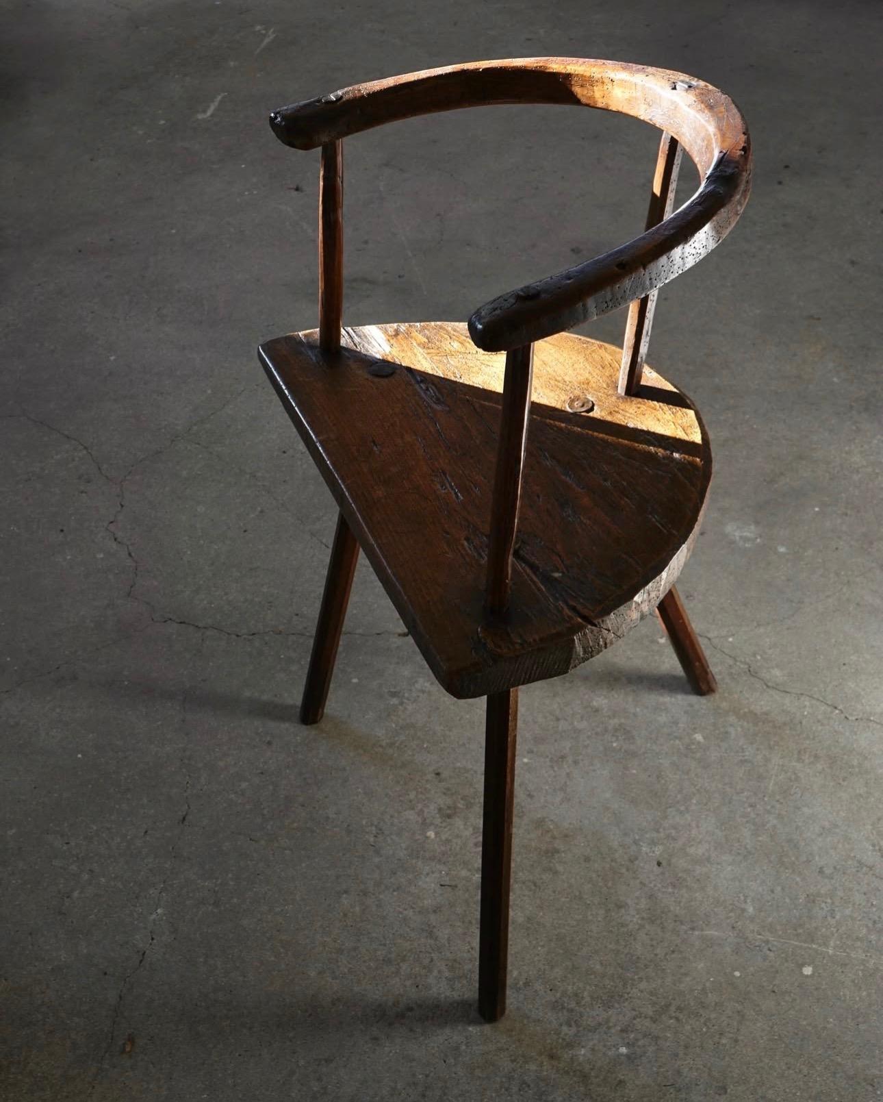Primitive three-legged wooden chair, end of 18th century
