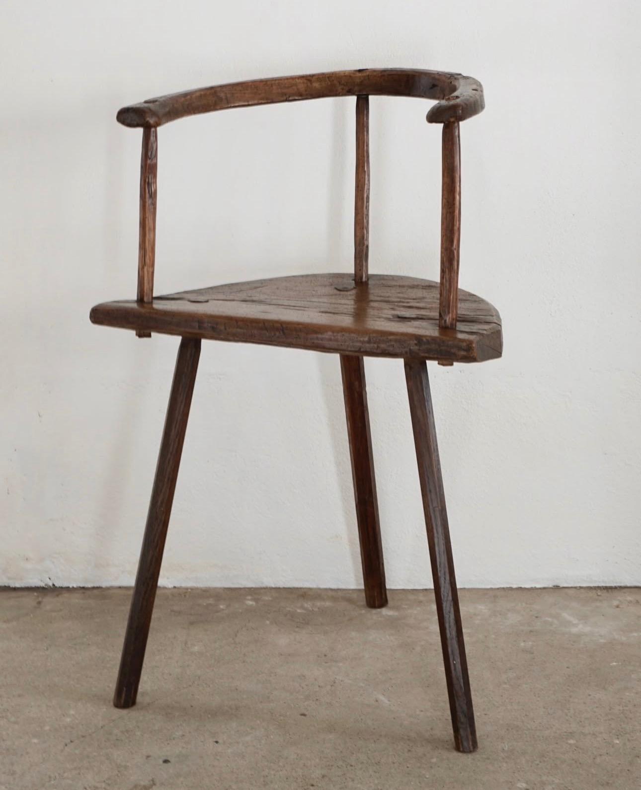 Primitive three-legged wooden chair, end of 18th century