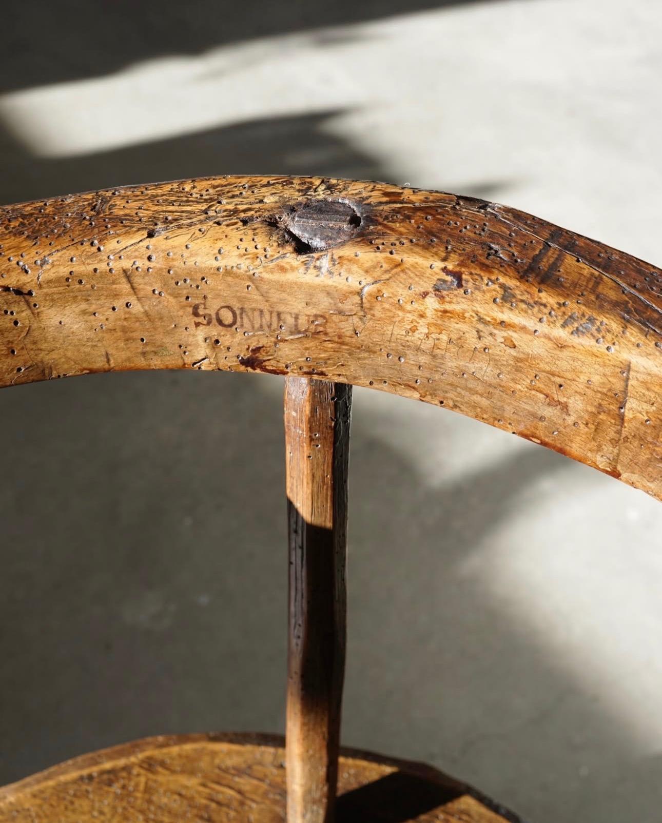 Primitive three-legged wooden chair, end of 18th century